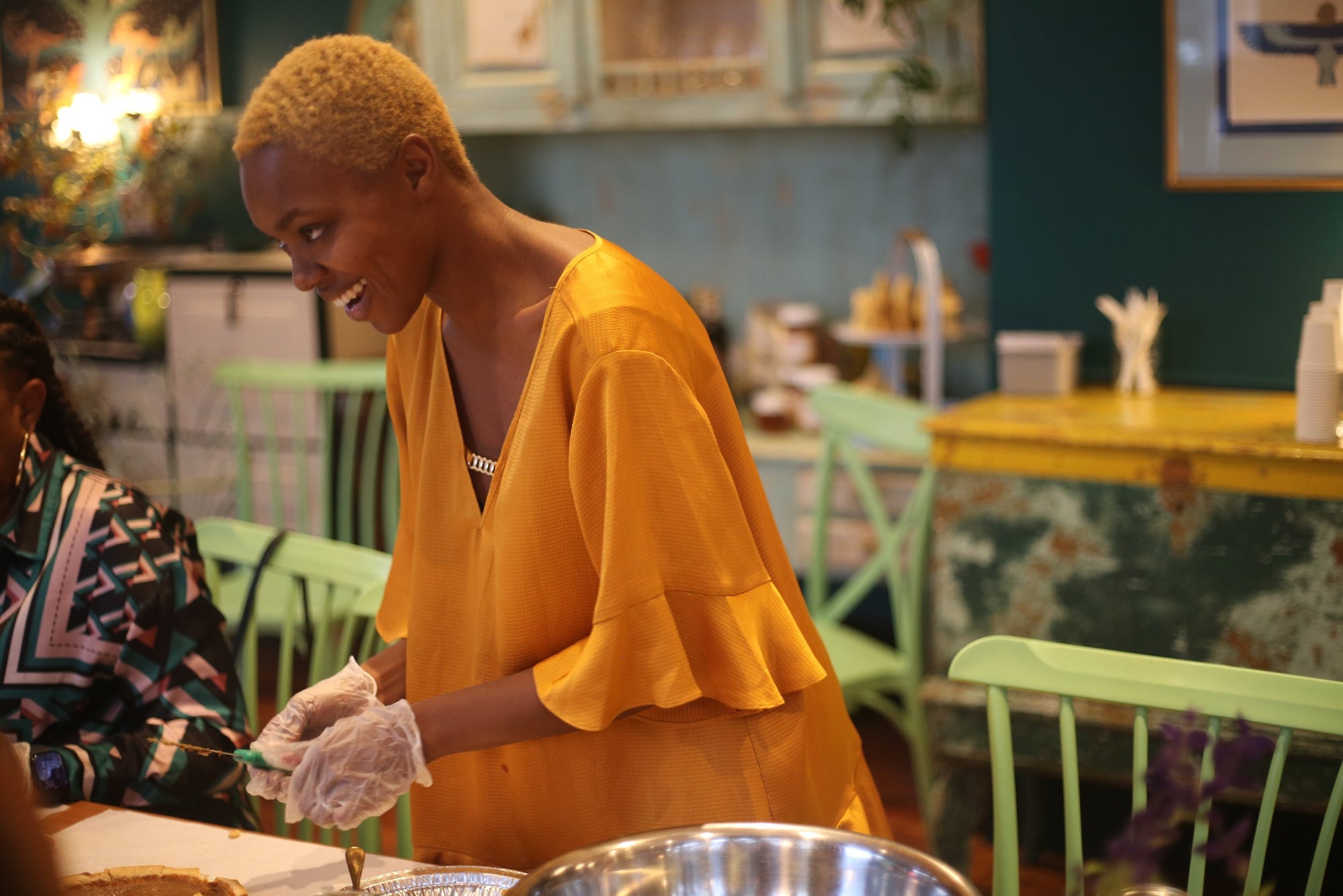 Nydia Simone of Blactina Media cutting a serving of pie at Gullah Geechee Cooking class in Martha's Vineyard